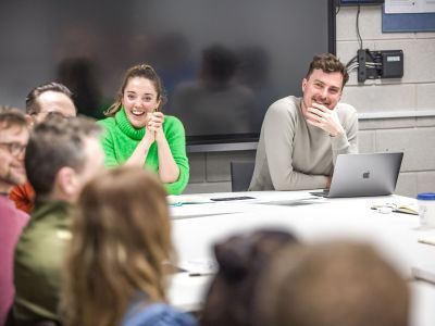 people sitting around at a table and smiling